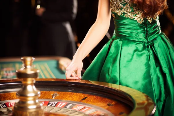 A young woman relaxing with her phone while dynamic casino elements float around her, illustrating the smooth mobile experience offered by the JL56 app.
